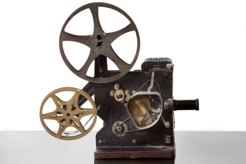 a vintage movie projector on a white background with the working visable