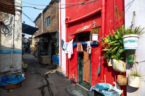 This image captures the Worli Fishing Village in Mumbai, a community steeped in traditional fishing practices, juxtaposed against the backdrop of a rapidly urbanizing city. The village's rustic charm is evident in its small, colorfully painted houses and narrow lanes. However, the photograph also reveals a less picturesque reality of the area – the issue of litter and pollution. The shores and streets are strewn with litter, reflecting a lack of adequate maintenance and waste management in this part of the city. Boats, both docked and preparing to set sail, are seen amidst this setting, symbolizing the daily challenges faced by the community. This image aims to highlight not just the cultural richness and simplicity of life in the Worli Fishing Village, but also the environmental and infrastructural issues that impact it, offering a candid look at the complexities of life in one of Mumbai's oldest fishing communities.