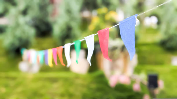 istock Low angle and focused view. Multicolored decorative party pennants in the park 1827319097