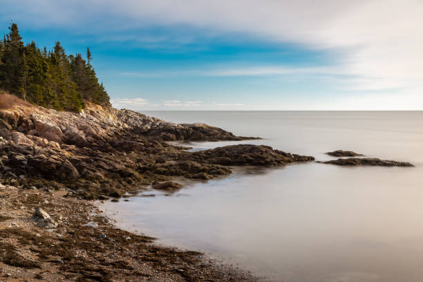 istock Serene coastal rocky beach with calm water 1827319620