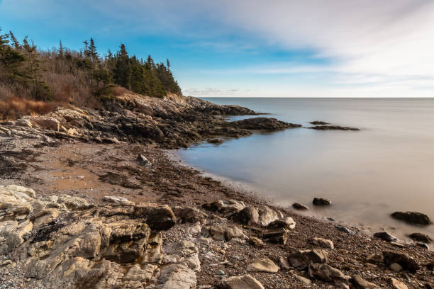 istock Serene coastal rocky beach with calm water 1827319621