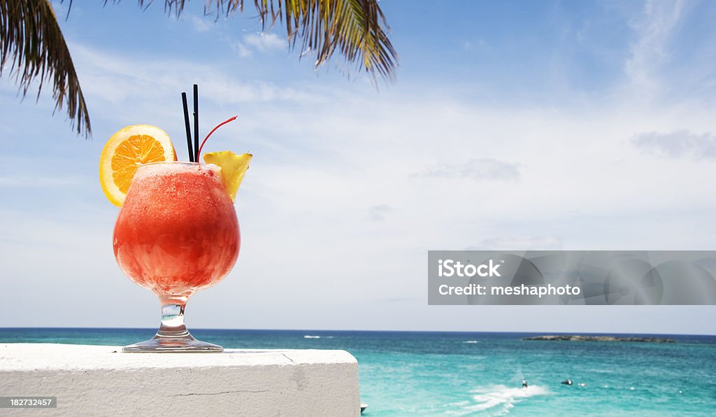 Tequila Sunrise in the Carribeans Cold tropical mixed drink by the sea. Alcohol - Drink Stock Photo