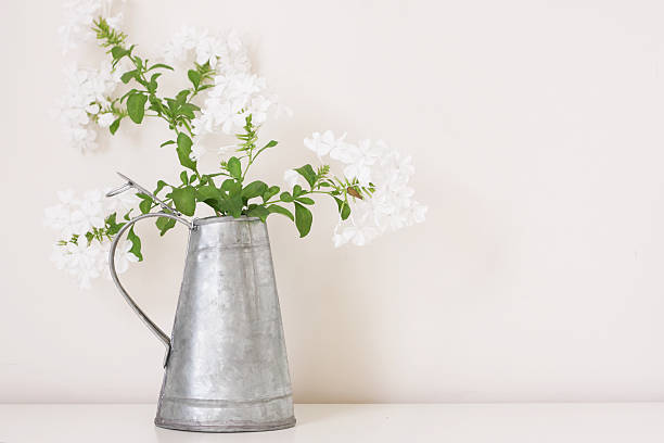 istock White flower arrangement on tin jar 182732556