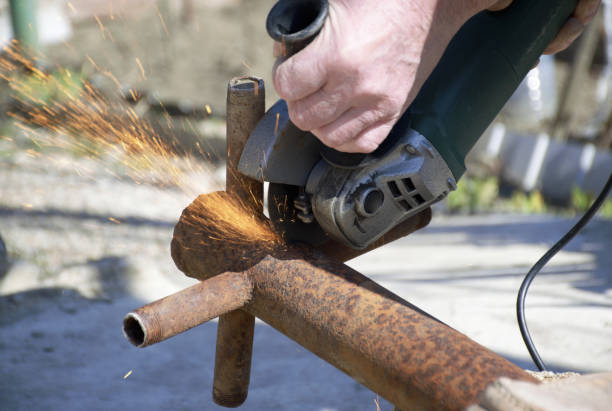 istock male hands hold a working power tool for cutting metal 1827331074