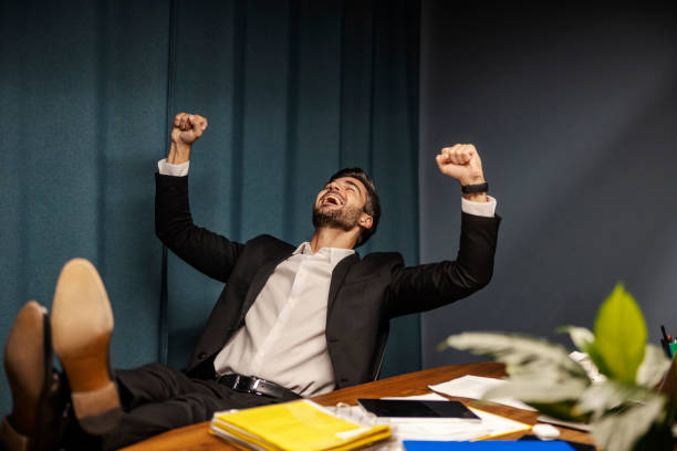 istock A cheerful businessman is relaxing and singing at his office. 1827334200