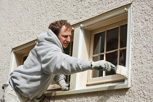 istock House Painter Working on Window Trim with Paint Brush Hz 182733555