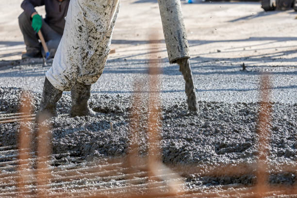 istock Construction worker is pouring and smoothing out concrete with ready-mix concrete (RMC). It is concrete that is manufactured in a batch plant, according to each specific job requirement. 1827335793