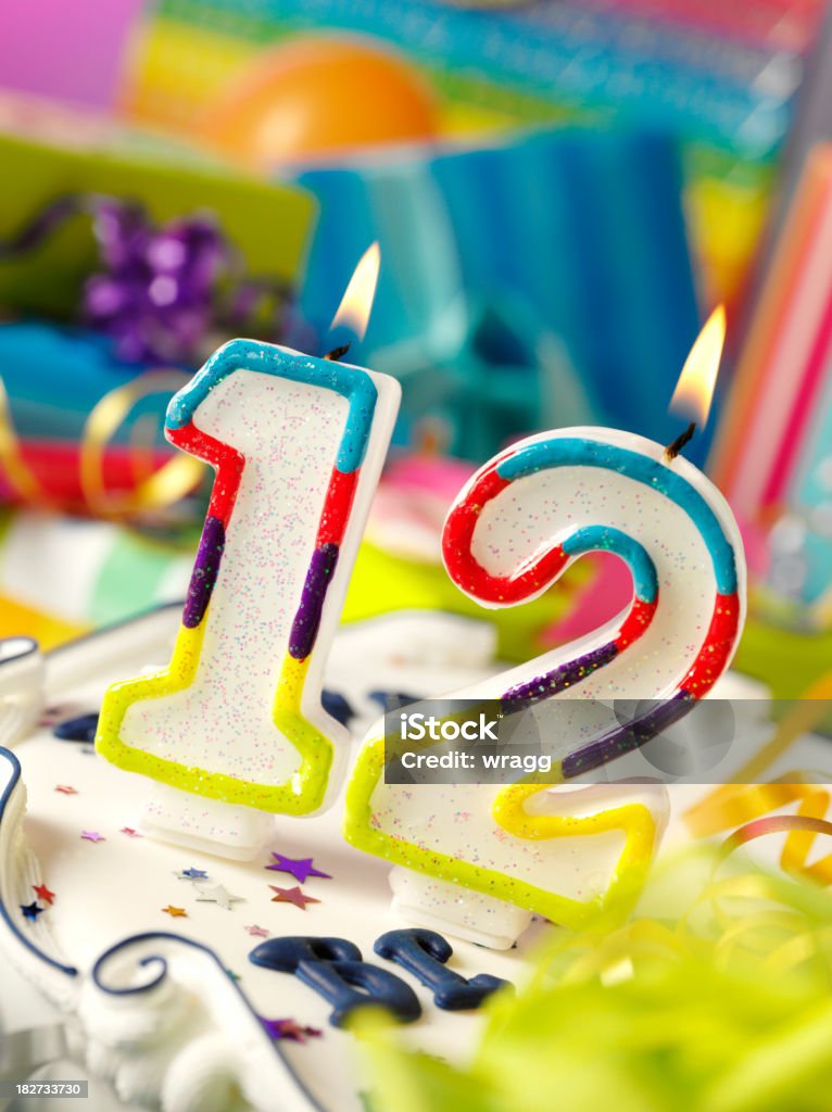 Number Twelve Birthday Candle Number twelve birthday candle with differential focus on the gifts. Birthday Stock Photo
