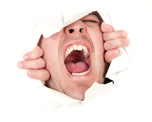 uomo di rottura attraverso il libro bianco e grida - human mouth paper screaming hole foto e immagini stock