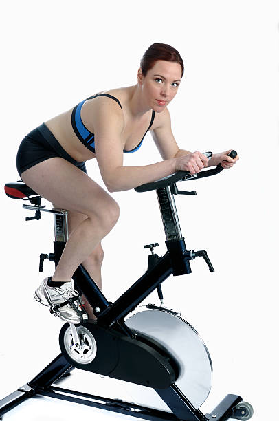 istock Female exercising on a bike 182734838