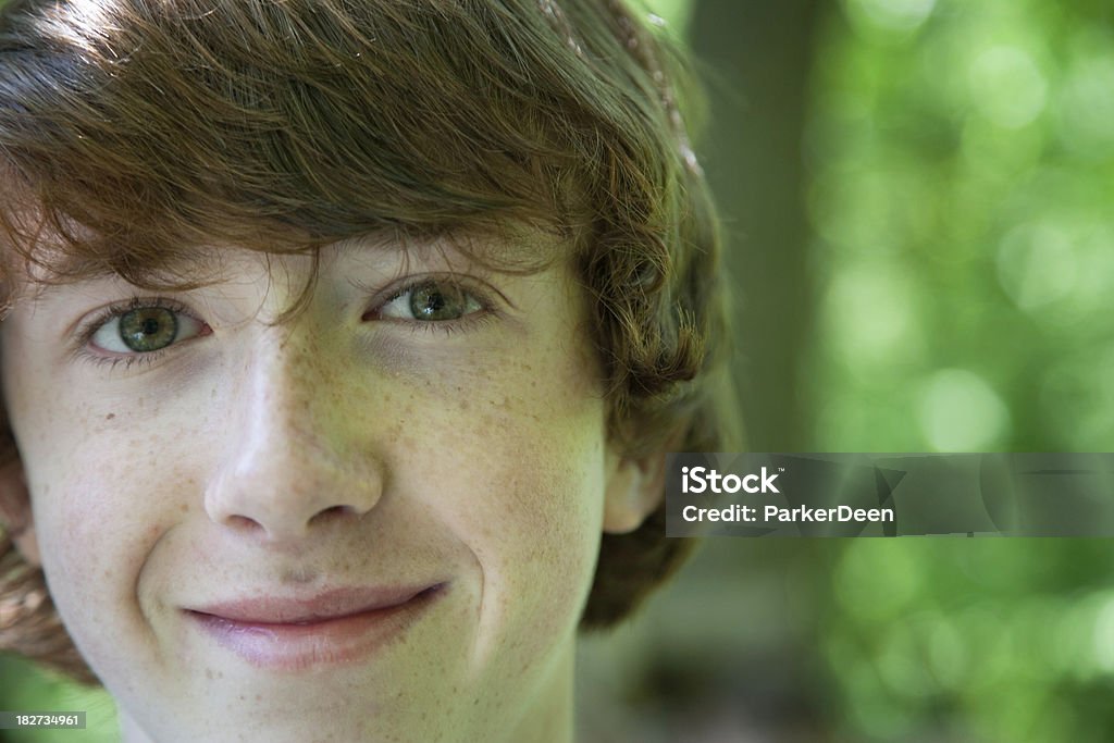 Cute Teen Boy Outside in Nature "Cute 15 year old boy in close up outdoor portraitShot with Canon 1Ds Mark II, image processed from a 16 bit RAW file.  Slight curves adjustment, copy space available." 14-15 Years Stock Photo