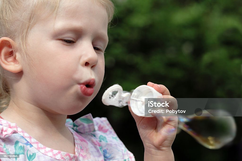 Blowing bubbles Girl making soap bubbles Child Stock Photo