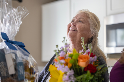 Family giving floral gifts to grandmother