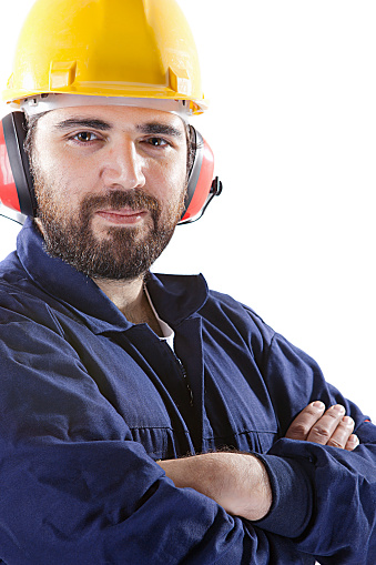 Man in working clothes,, hard hat and ear protection