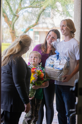 Family giving floral gifts to grandmother