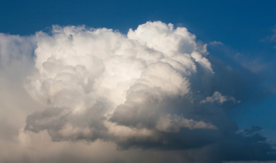 Beautiful storm clouds, cumulus clouds or cumulonimbus against a clear blue sky. Photography, Full frame.