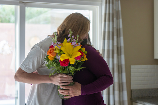 Family giving floral gifts to grandmother