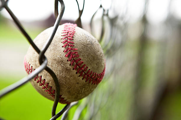 istock Baseball caught in chain link fence. 182735058