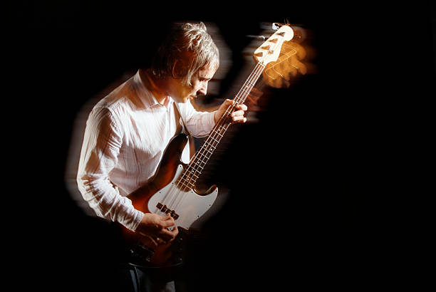 istock Bass guitar player with motion blur on black background 182735428