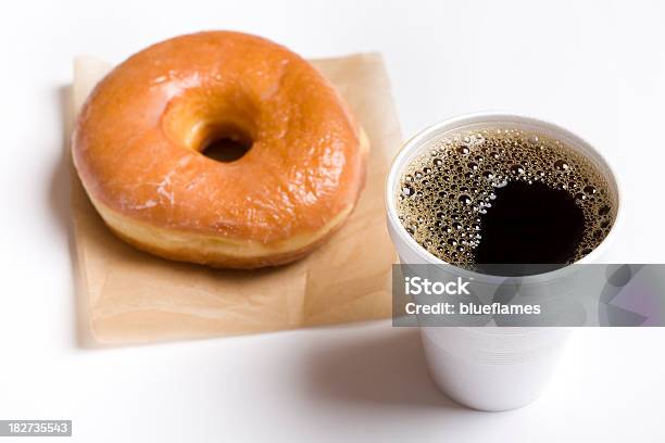 Closeup Of A Cup Of Black Coffee And A Glazed Donut Stock Photo - Download Image Now