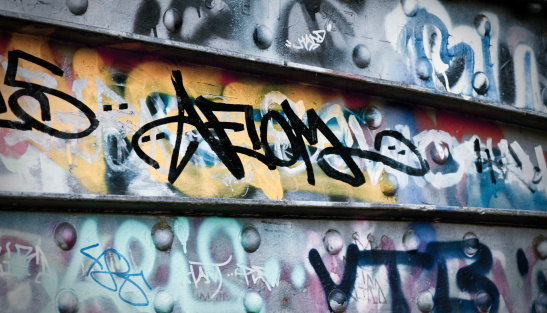 Ljubljana, Slovenia - August 21, 2020: A panorama picture of a building with street art on display at the Metelkova Art Center. The artist's name is Raze.