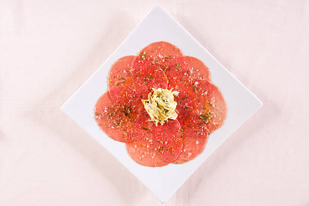 Antipasti Menu - Piedmontese Beef Carpaccio with Baby Artichoke Salad and Lemon. Copy space.