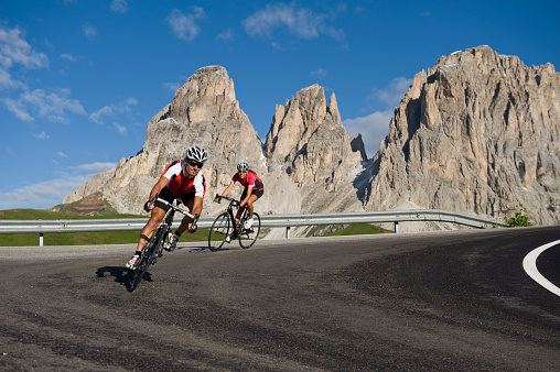 two cyclists with race bikes in downhill