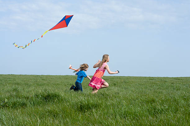istock Two young children outside on a sunny day kite flying 182736271