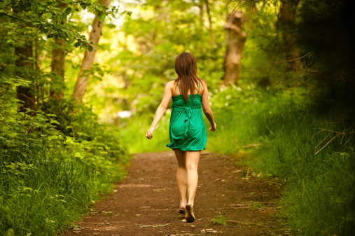 This is an image of a woman running through a forest path.click the banner below for similar images