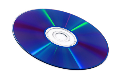 Close up of compact disc dvd cd appearing colored in rainbow colors as data carrier on white background