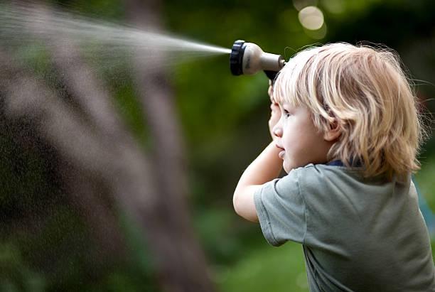 istock Little boy watering the garden 182736734