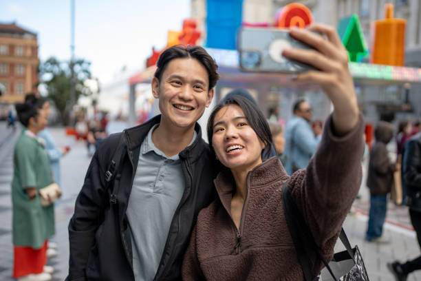 istock Young Asian Couple Taking Selfie 1827368633