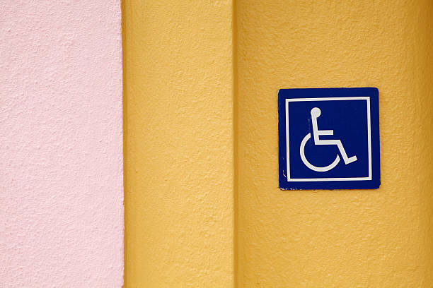 Wheelchair Accessible Sign, Art Deco Stucco Wall, ADA Icon stock photo