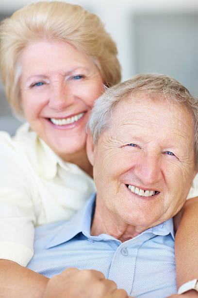 istock Old man being hugged by a woman from behind 182736950