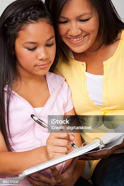 Asian Mother And Daughter Doing Homework Stock Photo - Download Image Now - Friendship, Adolescence, Adult