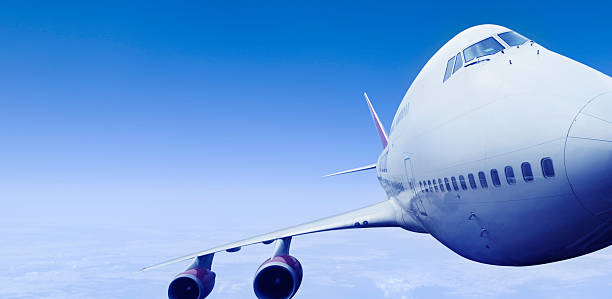 istock Head On View of Airliner with Clear Blue Sky 182737114