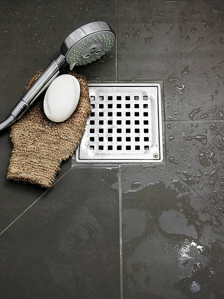 Wet bathroom with bathing utensils on the floor stock photo