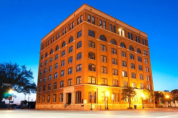 "The former Texas School Book Depository in Dallas Texas from which Lee Harvery Oswald fired the shots that killed President John F. Kennedy November 22, 1963.  The shots were fired from the sixth floor corner window on the Commerce (left) Street side.  Blue Hour, Horizontal orientation."