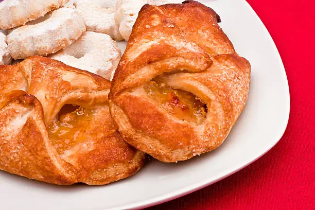 Delicious dish for a sweet breakfast: bundles of apples and some typical italians biscuits.