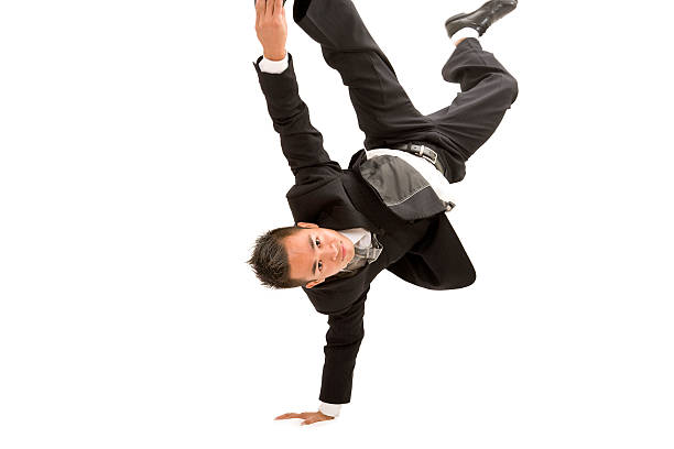 businessman handstand stock photo