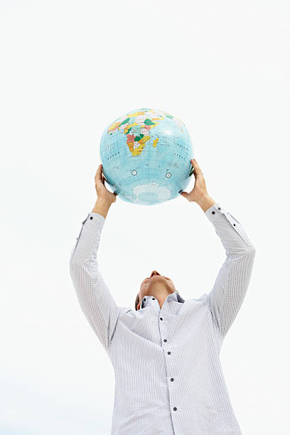 istock Mature man holding a world globe over head 182737752