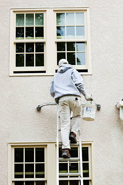 istock House Painter Up on Ladder Painting Exterior Window Frame Vt 182739154