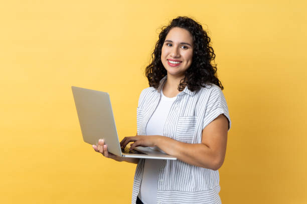 istock Satisfied woman working on laptop, looking at camera screen with pleasant expression. 1827391808