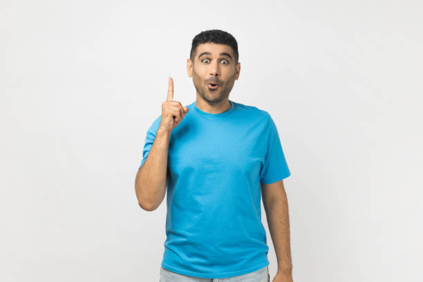 istock Excited clever smart man standing with finger up, having idea, looking at camera with surprised face 1827392276
