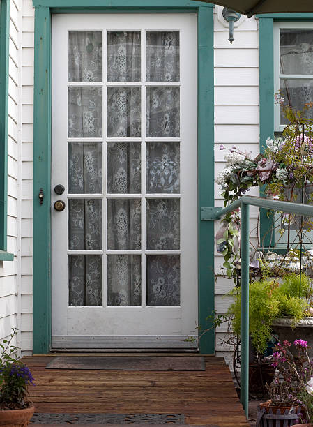 istock Old fashioned white door with lace curtains 182739318