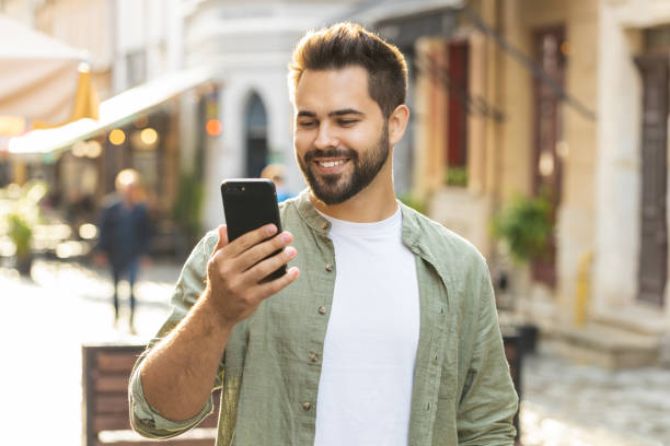 istock Young adult man use smartphone typing text messages browsing internet finishing work chatting online 1827398161