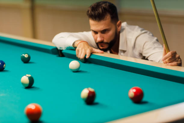 istock Billiard player at billard table or snooker american billiards pool sport game 1827399253