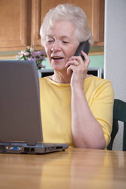 istock Woman on the phone, looking at laptop 182740134