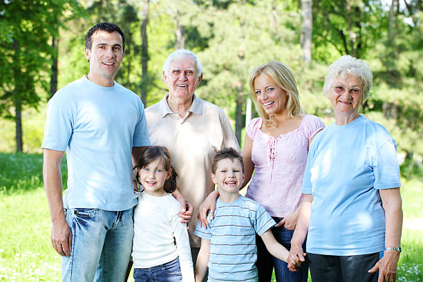istock Extended happy family standing in the park. 182740252