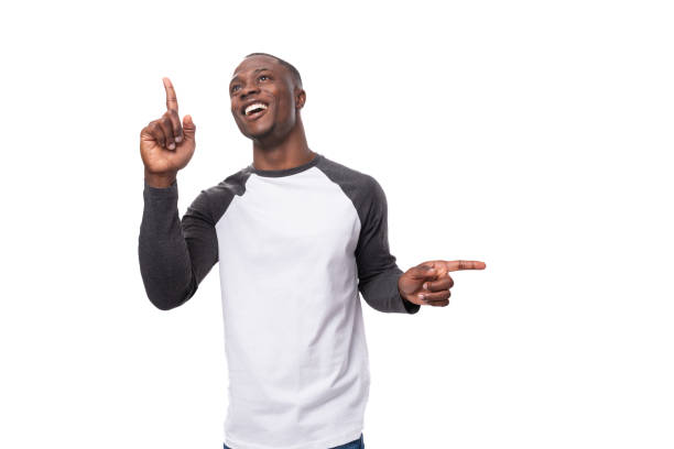 istock young positive african man dressed in a spring jacket points his finger to the side 1827404200